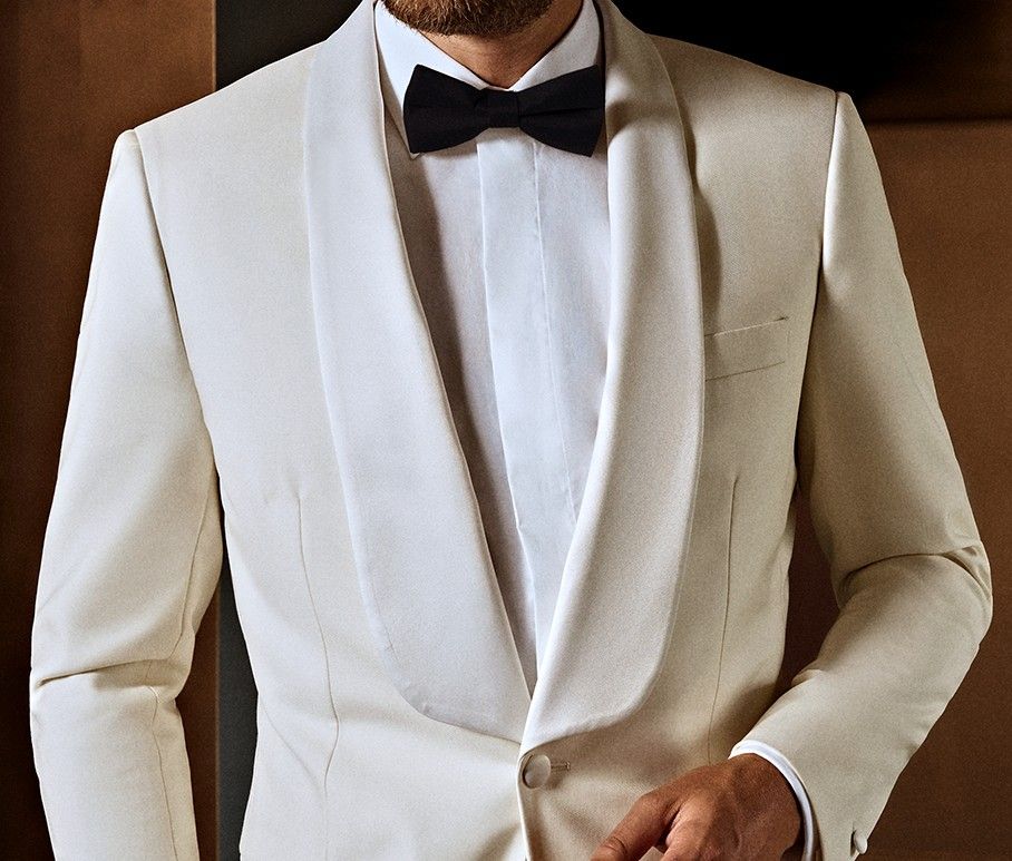 Sleek white custom made tuxedo, perfect for black tie occasions and tailored to the individual