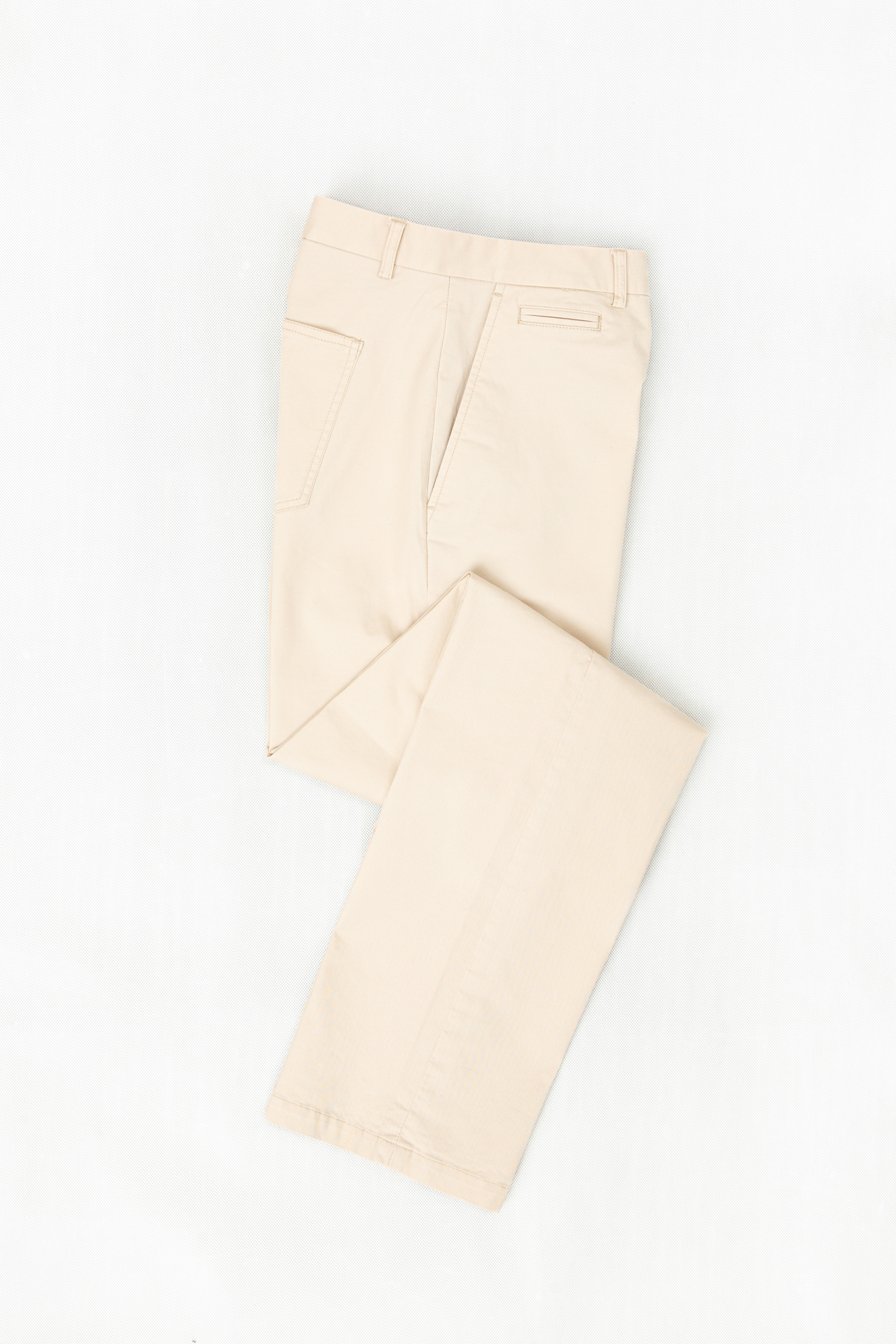 Flat lay of cream colored chinos, which can be custom tailored to your fit and frame
