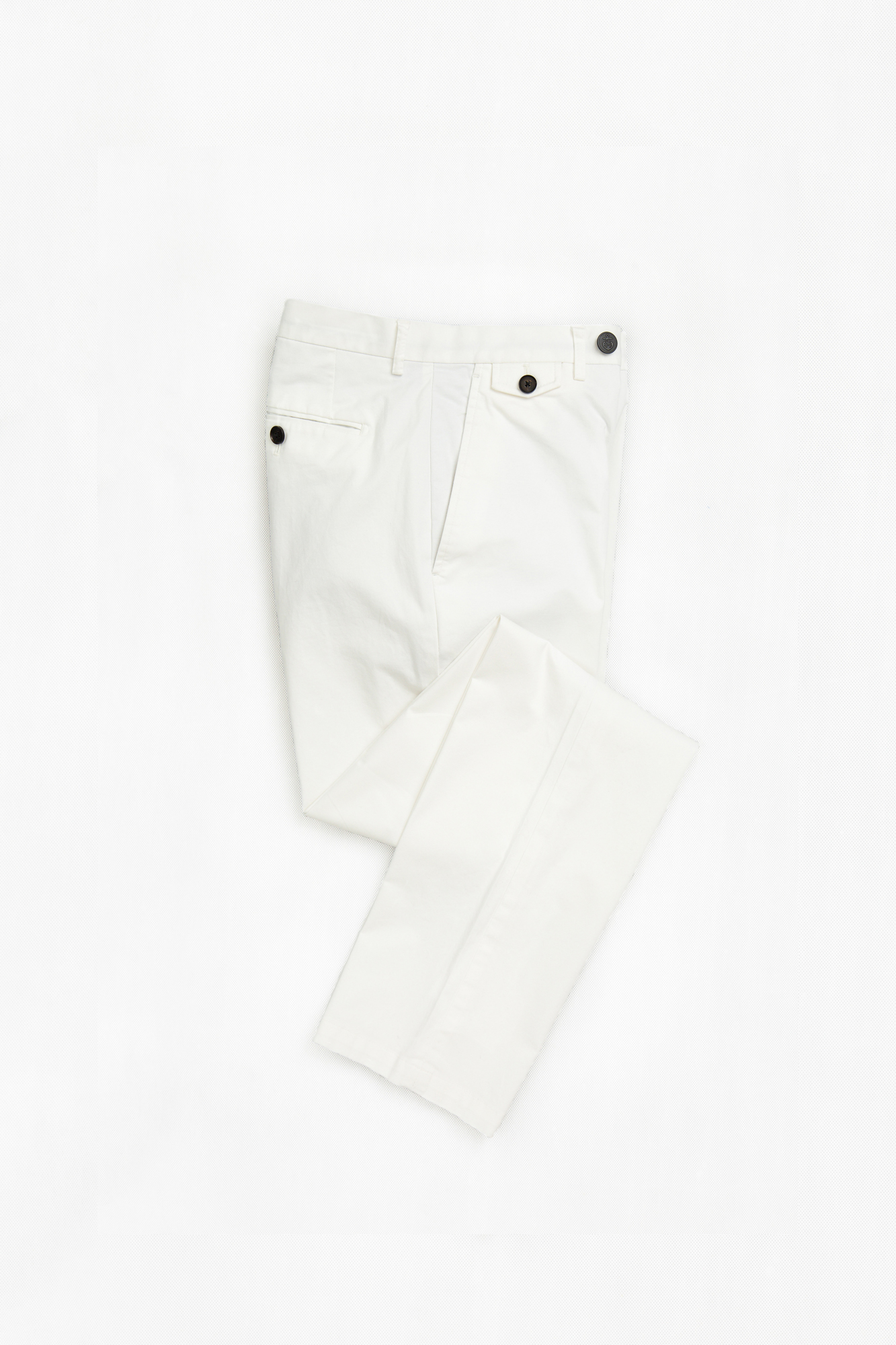 Flat lay of white chinos, custom tailored by Senszio to each individual