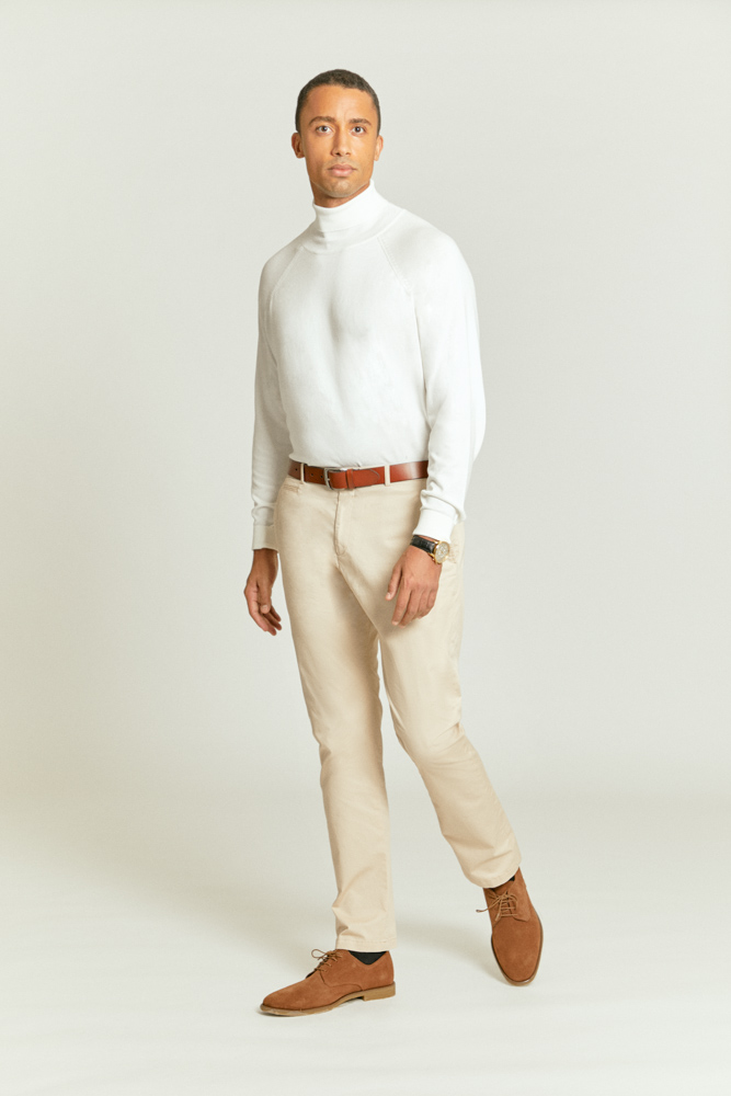 Stylish cream chinos combined with brown shoes, brown belt and white rollneck jumper for a timeless and comfortable look