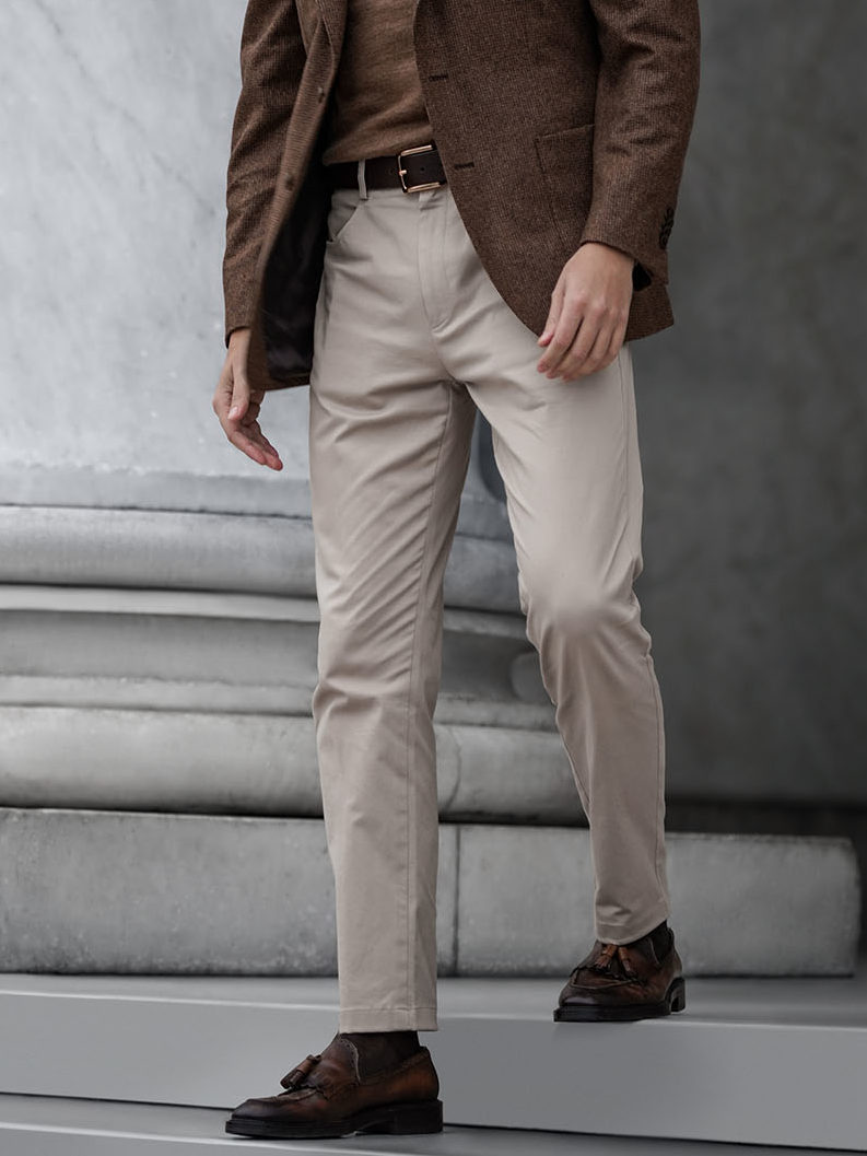 Chino Page Man Wearing Light Khaki Chino Steps Down The Stairs 3